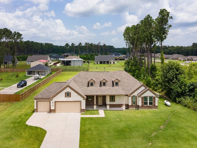 2018 Rd 660, Dayton, TX 77535 - view of front facade with driveway, an attached garage, covered porch, and brick siding