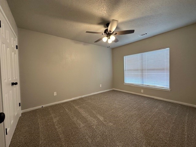 2102 Autumn Cove Dr, League City, TX 77573 - unfurnished room with ceiling fan, carpet, and a textured ceiling