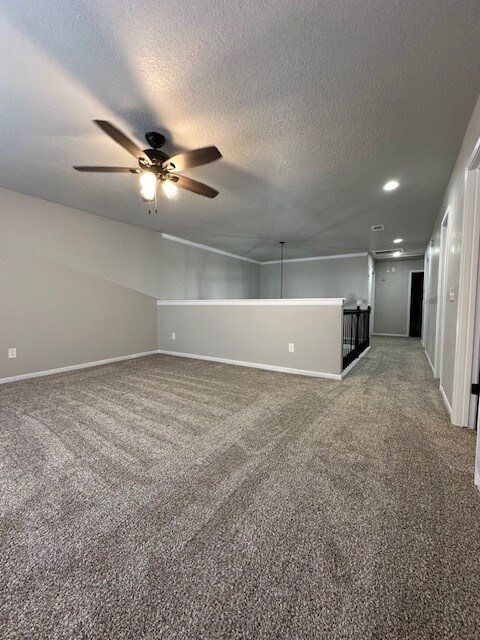 2102 Autumn Cove Dr, League City, TX 77573 - carpeted empty room with a ceiling fan, a textured ceiling, and recessed lighting
