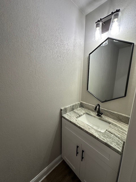 2102 Autumn Cove Dr, League City, TX 77573 - bathroom with vanity, wood finished floors, and a textured wall