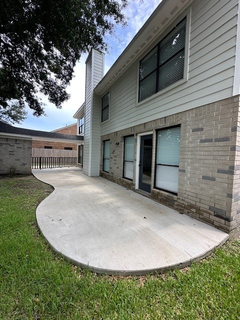 2102 Autumn Cove Dr, League City, TX 77573 - back of property featuring a patio, a chimney, and brick siding