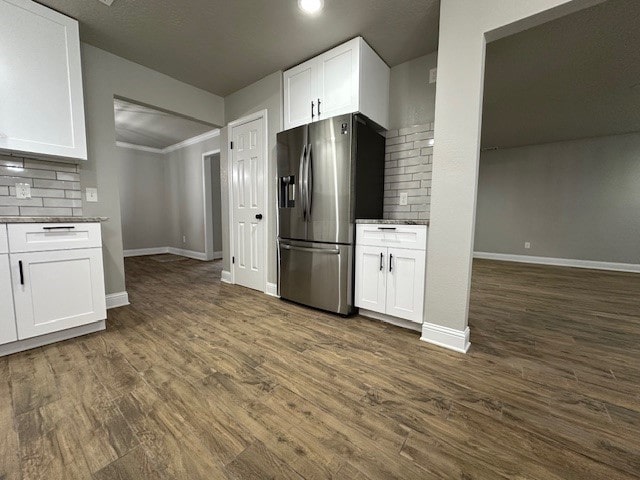 2102 Autumn Cove Dr, League City, TX 77573 - kitchen featuring stainless steel fridge with ice dispenser, white cabinetry, decorative backsplash, dark wood finished floors, and recessed lighting