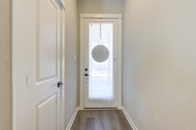 320 Parker Willow Ln, Houston, TX 77076 - doorway to outside featuring baseboards and dark wood-style flooring