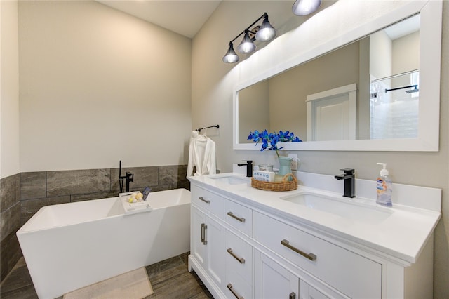 320 Parker Willow Ln, Houston, TX 77076 - bathroom featuring double vanity, a freestanding bath, tile walls, and a shower
