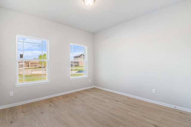 12359 Pecan Dr, Willis, TX 77318 - spare room featuring wood finished floors and baseboards