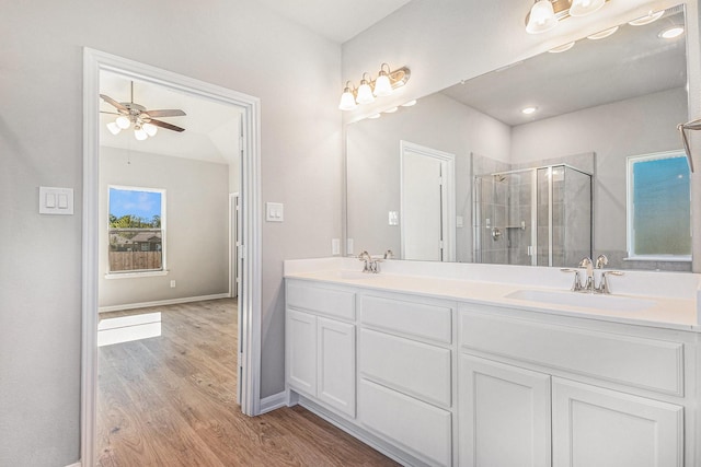 12359 Pecan Dr, Willis, TX 77318 - bathroom featuring double vanity, a shower stall, wood finished floors, and ceiling fan