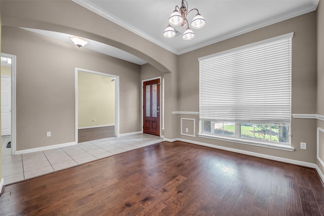 5531 Cherish Trl, Katy, TX 77494 - foyer entrance featuring arched walkways, hardwood / wood-style floors, a chandelier, and crown molding