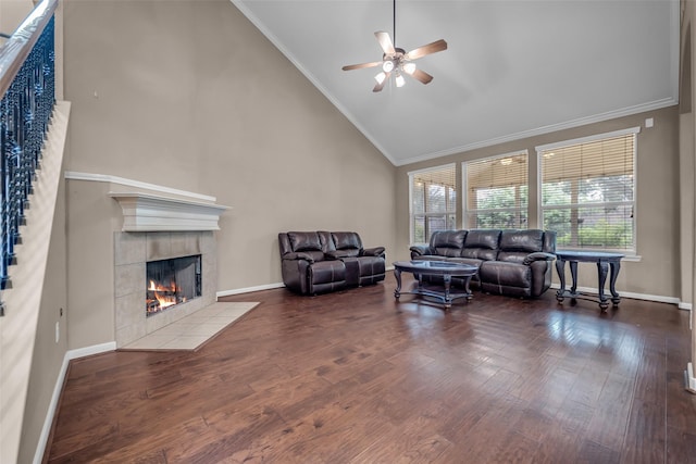 5531 Cherish Trl, Katy, TX 77494 - living area featuring a tile fireplace, a ceiling fan, wood finished floors, ornamental molding, and high vaulted ceiling