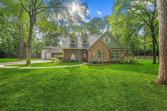 27210 Hitching Post Ct, Magnolia, TX 77355 - view of front facade featuring concrete driveway, brick siding, a chimney, and stone siding