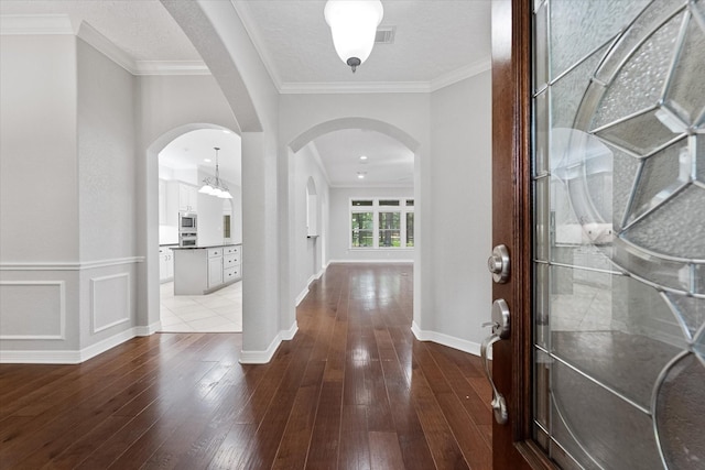 27210 Hitching Post Ct, Magnolia, TX 77355 - entryway featuring arched walkways, hardwood / wood-style floors, and ornamental molding