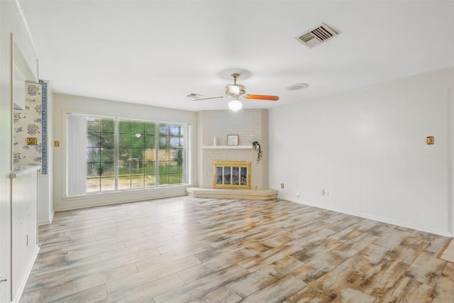 7826 Braesview Ln, Houston, TX 77071 - unfurnished living room featuring light wood-style flooring, a ceiling fan, and a fireplace