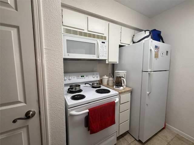 5711 Sugar Hill Dr Unit 46, Houston, TX 77057 - kitchen featuring white appliances, white cabinetry, light countertops, and light tile patterned floors