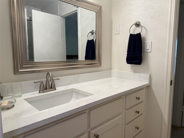 5711 Sugar Hill Dr Unit 46, Houston, TX 77057 - bathroom featuring a textured wall and vanity