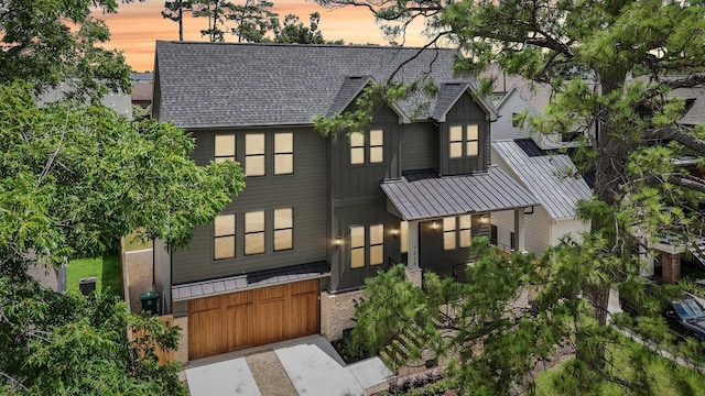 1023 Grovewood Ln, Houston, TX 77008 - view of front of house with a standing seam roof, a shingled roof, and a metal roof