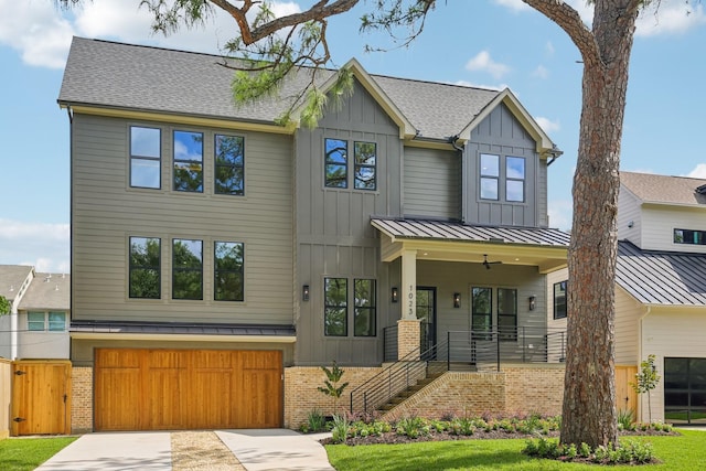 1023 Grovewood Ln, Houston, TX 77008 - view of front of property featuring a garage, board and batten siding, a porch, concrete driveway, and a standing seam roof