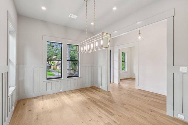 1023 Grovewood Ln, Houston, TX 77008 - unfurnished dining area featuring healthy amount of natural light, light wood-type flooring, a decorative wall, a wainscoted wall, and recessed lighting