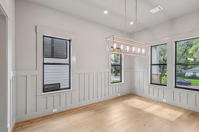 1023 Grovewood Ln, Houston, TX 77008 - spare room featuring a wainscoted wall, wood finished floors, a decorative wall, a chandelier, and recessed lighting