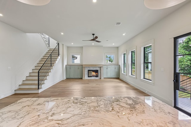 1023 Grovewood Ln, Houston, TX 77008 - unfurnished living room with healthy amount of natural light, a ceiling fan, wood finished floors, stairs, and recessed lighting