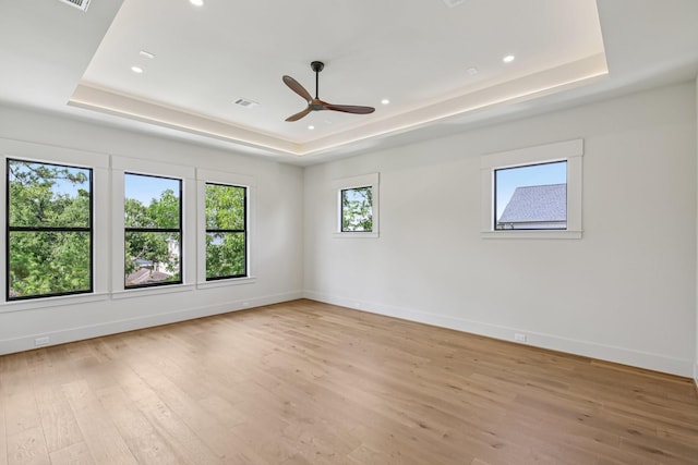 1023 Grovewood Ln, Houston, TX 77008 - spare room with a raised ceiling, ceiling fan, light wood-style floors, and recessed lighting
