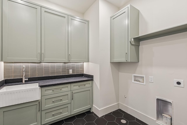 1023 Grovewood Ln, Houston, TX 77008 - laundry room featuring hookup for an electric dryer, cabinet space, gas dryer hookup, hookup for a washing machine, and dark tile patterned flooring