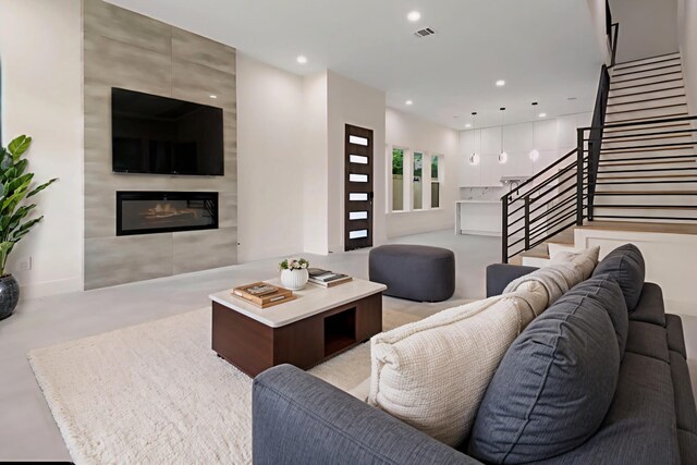 5117 Schuler St Unit B, Houston, TX 77007 - living area featuring stairs, a tile fireplace, recessed lighting, and concrete flooring