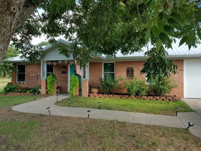 2401 Country Meadows Ln, Brenham, TX 77833 - single story home featuring brick siding, an attached garage, and a front yard