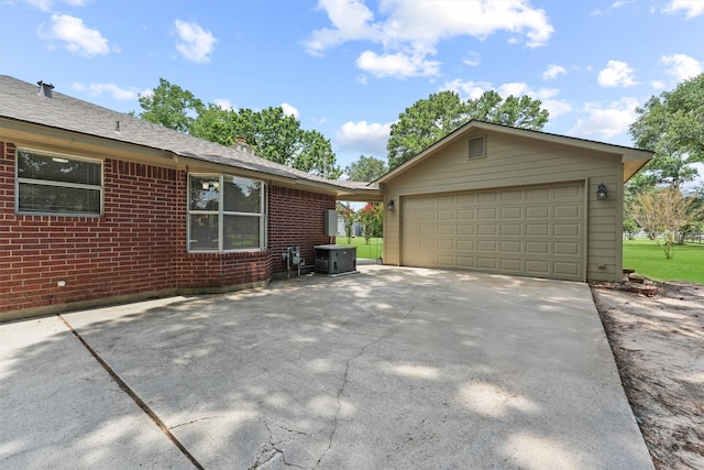 17010 Cypress Knee Dr, Cypress, TX 77429 - view of home's exterior with a garage, brick siding, an outbuilding, and concrete driveway