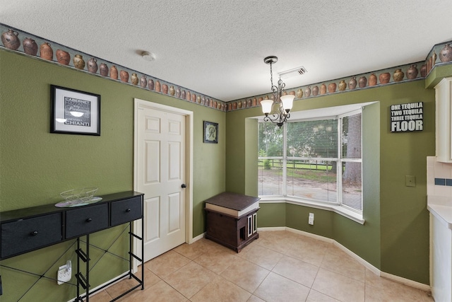 17010 Cypress Knee Dr, Cypress, TX 77429 - unfurnished dining area with a chandelier, light tile patterned floors, and a textured ceiling