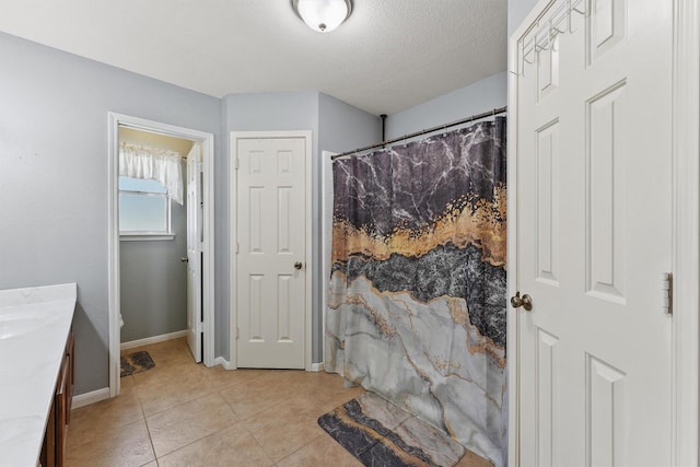17010 Cypress Knee Dr, Cypress, TX 77429 - full bath featuring vanity, tile patterned flooring, a textured ceiling, and curtained shower