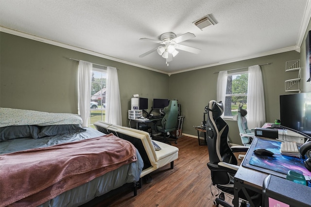 17010 Cypress Knee Dr, Cypress, TX 77429 - bedroom with multiple windows, ornamental molding, a desk, wood finished floors, and a ceiling fan