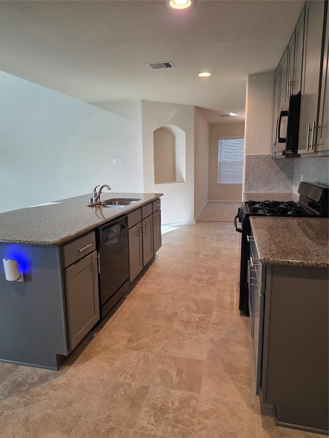 15319 Roaming River Trl, Houston, TX 77044 - kitchen with black appliances, gray cabinetry, dark stone countertops, tasteful backsplash, and recessed lighting