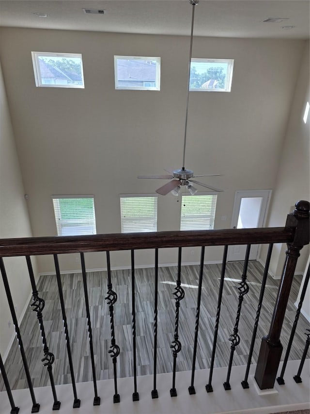 15319 Roaming River Trl, Houston, TX 77044 - staircase featuring baseboards and a high ceiling
