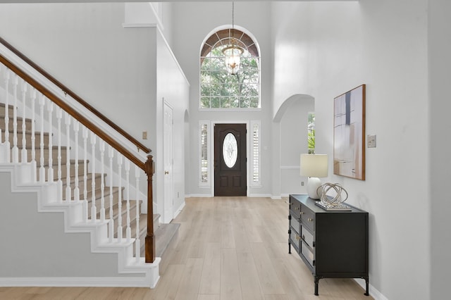 1622 Maryvale Dr, Katy, TX 77494 - entryway with a towering ceiling, stairway, arched walkways, healthy amount of natural light, and light wood-style floors