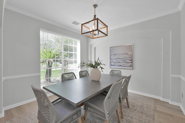 1622 Maryvale Dr, Katy, TX 77494 - dining area with a chandelier, crown molding, and light wood-style floors