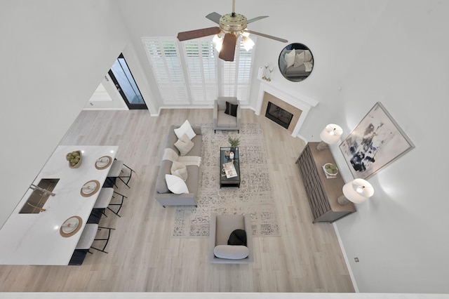 1622 Maryvale Dr, Katy, TX 77494 - living room featuring ceiling fan, wood finished floors, and a glass covered fireplace