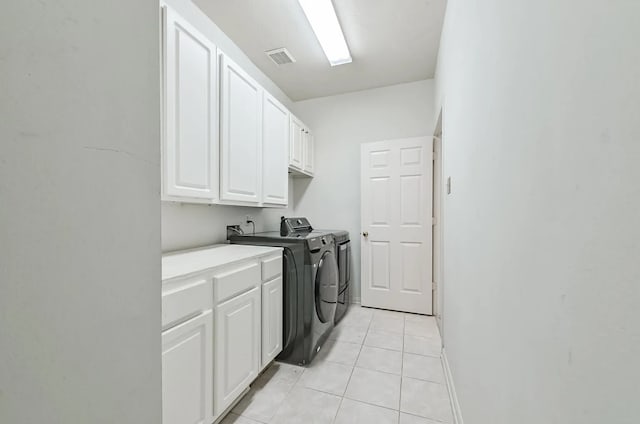 1622 Maryvale Dr, Katy, TX 77494 - washroom with cabinet space, independent washer and dryer, and light tile patterned flooring