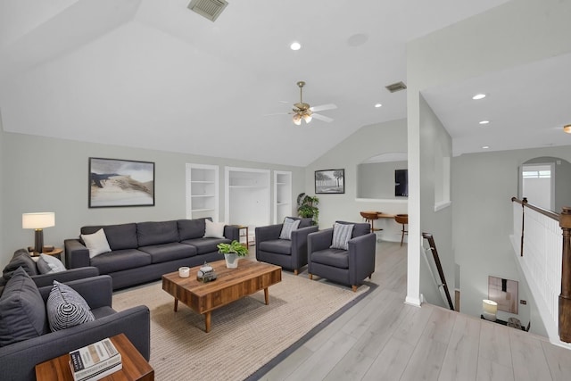 1622 Maryvale Dr, Katy, TX 77494 - living room with arched walkways, lofted ceiling, a ceiling fan, light wood-style flooring, and built in shelves