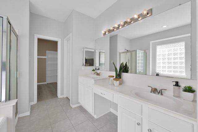 1622 Maryvale Dr, Katy, TX 77494 - bathroom with a shower stall, double vanity, tile patterned floors, and a walk in closet