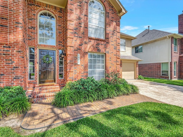1227 Redwood Bough Ln, Houston, TX 77062 - view of exterior entry featuring driveway, brick siding, and a garage