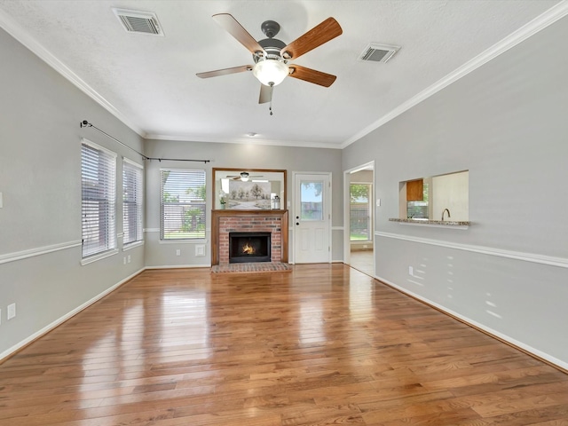 1227 Redwood Bough Ln, Houston, TX 77062 - unfurnished living room featuring ceiling fan, light wood-style flooring, a fireplace, and crown molding