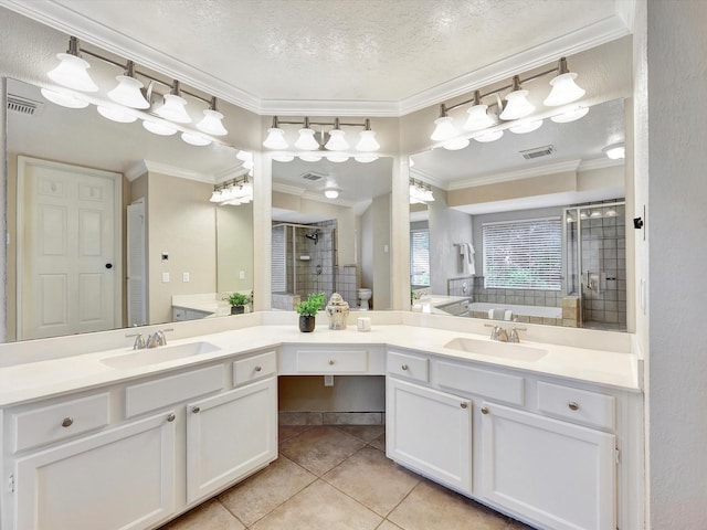 1227 Redwood Bough Ln, Houston, TX 77062 - bathroom featuring tile patterned floors, double vanity, a shower stall, crown molding, and a garden tub