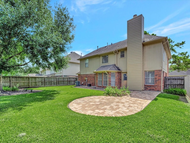 1227 Redwood Bough Ln, Houston, TX 77062 - back of property featuring brick siding, a patio, a chimney, a fenced backyard, and a shingled roof