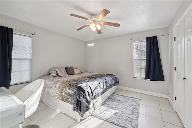 11156 Country Ln, Beaumont, TX 77705 - bedroom with ceiling fan, light tile patterned floors, and a closet