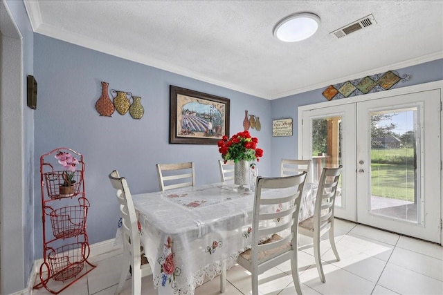 11156 Country Ln, Beaumont, TX 77705 - dining area with a textured ceiling, french doors, ornamental molding, and light tile patterned floors