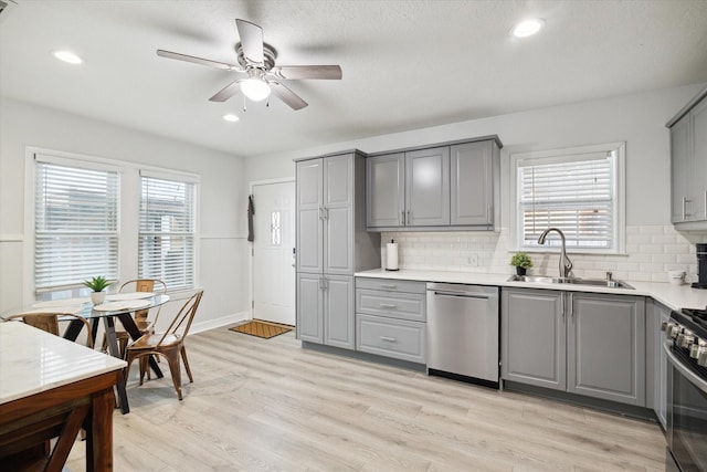 1115 Alber St, Houston, TX 77009 - kitchen featuring gray cabinetry, stainless steel appliances, ceiling fan, backsplash, and recessed lighting