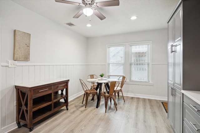 1115 Alber St, Houston, TX 77009 - dining area featuring light wood finished floors, a wainscoted wall, ceiling fan, and recessed lighting