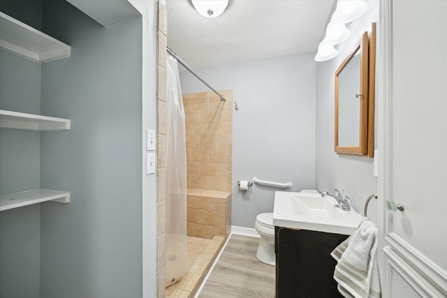 1115 Alber St, Houston, TX 77009 - bathroom with vanity, tiled shower, and wood finished floors