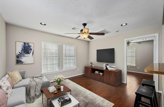 1115 Alber St, Houston, TX 77009 - living area with ceiling fan, dark wood-style floors, recessed lighting, and a textured ceiling