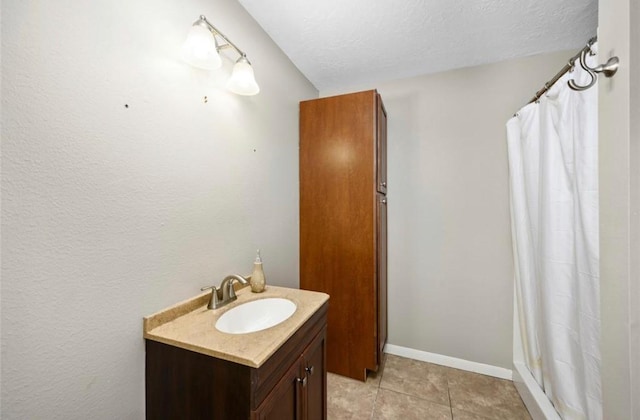 1115 Alber St, Houston, TX 77009 - bathroom with vanity, a shower with curtain, tile patterned flooring, and a textured ceiling