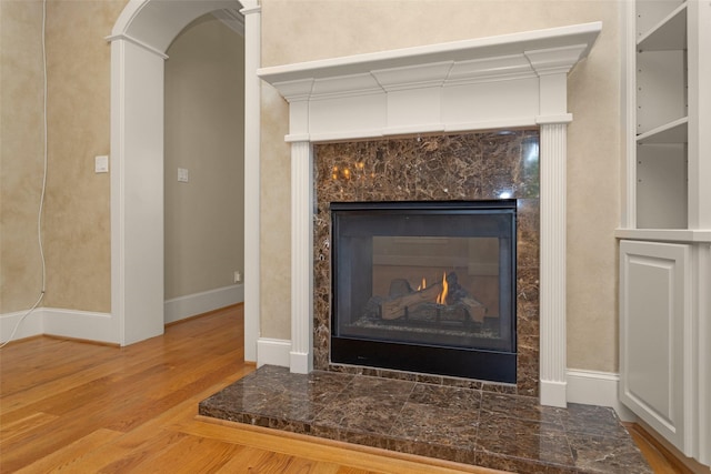6616 Queensclub Dr, Houston, TX 77069 - detailed view of a premium fireplace, wood finished floors, and arched walkways
